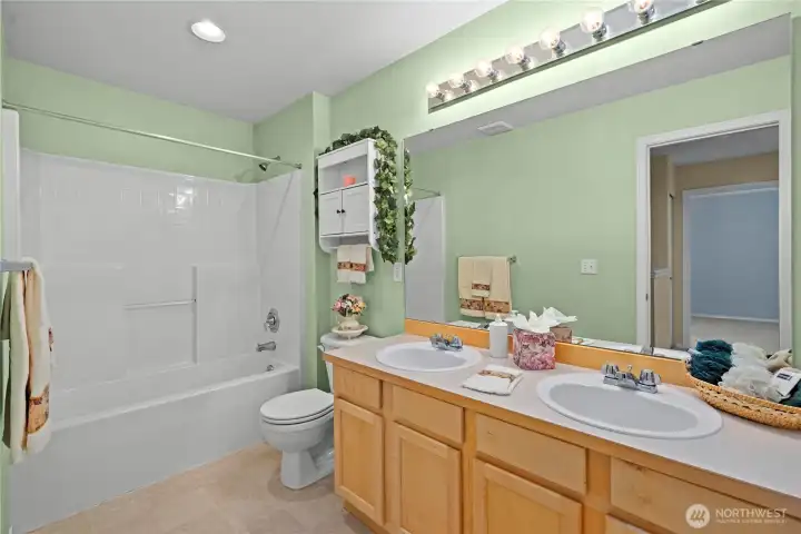 The upstairs full bath also has dual sinks, maple shaker style cabinets and a roomy tub/shower The upstairs full bath also has dual sinks, maple shaker style cabinets and a roomy tub/shower