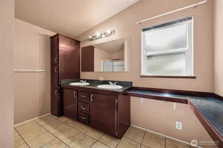 Primary bath attached with double vanity and shower.