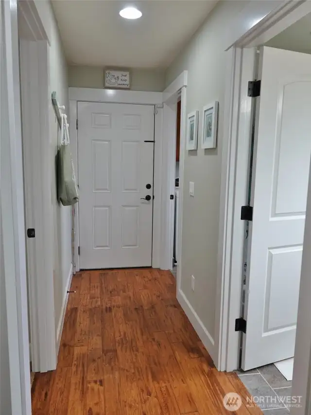 Entry w/ doors to the laundry room, full bath, and bedroom.