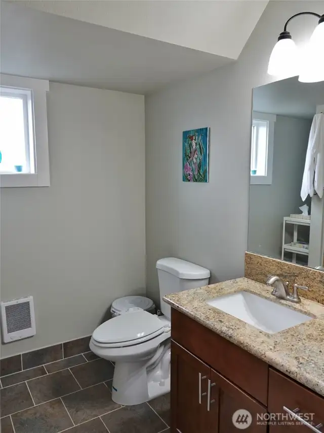 Upstairs Bathroom w/ tile floors and wlak-in shower.