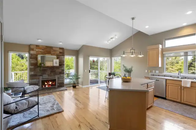 Gleaming hardwood floors lead you into a second gathering space, made even cozier with a second stone-surrounded fireplace.