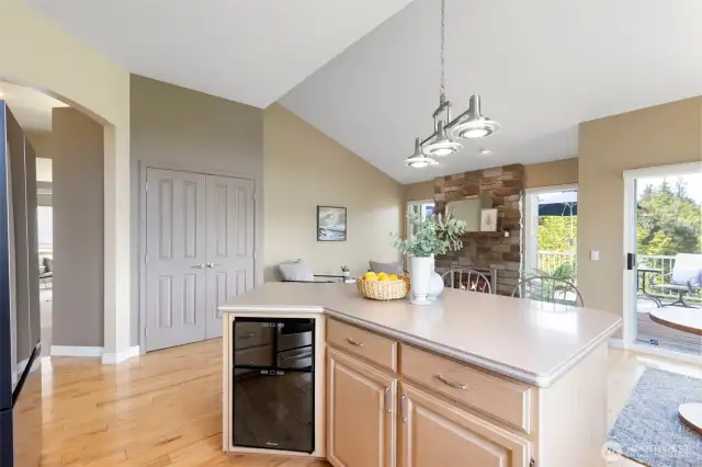 Roomy island with wine refrigerator makes entertaining a pleasure. The double-doors enclose a roomy pantry.