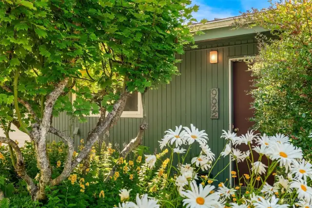 The front entry is tucked away in the secret garden behind the privacy fence. This home really feels private and peaceful. Best home in the neighborhood!