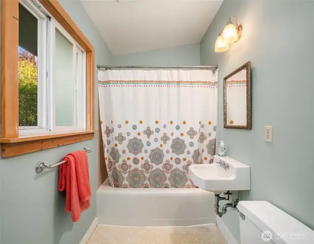 Main bathroom with fresh paint, wood window trim and lots of storage; bank of shelves as you enter.