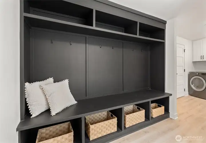 Upstairs laundry with 1/2 bath and custom "cubby" space.