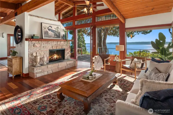 An architectural celebration of light and craftsmanship - where exposed wood beams, a stone-clad hearth, and walls of glass invite Puget Sound’s shimmering blues into every corner.