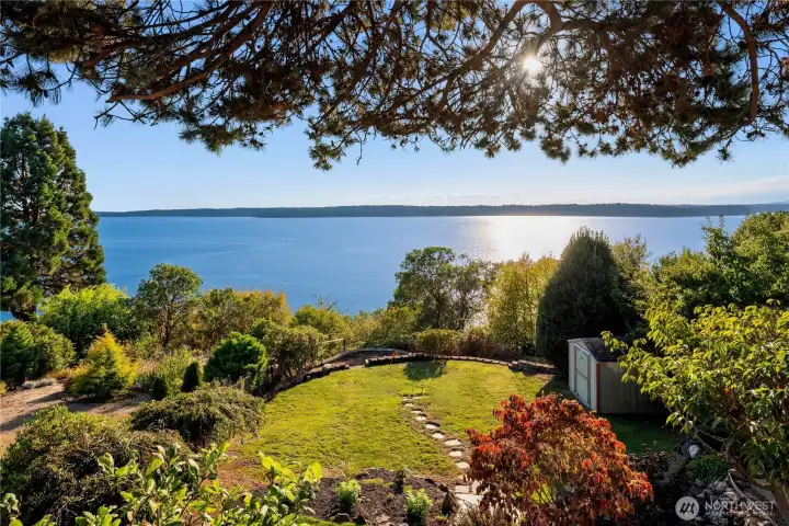 Terraced landscaping and lush lawn overlook the sparkling Sound, creating a peaceful and private backyard retreat.
