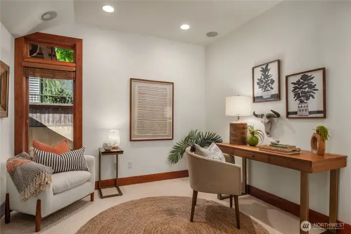Inviting home office or flex space offering a stylish and calming environment for work or relaxation.
