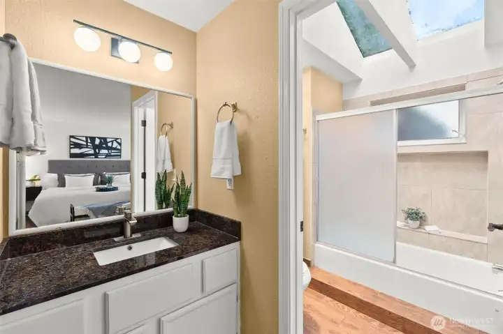 A primary bathroom with the most gorgeous vaulted ceilings and skylights that let in beautiful natural light.