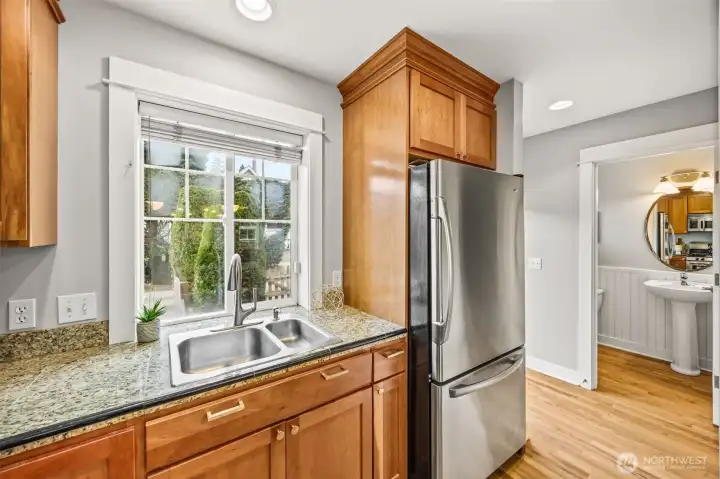 Warm kitchen overlooking front yard and private alley.