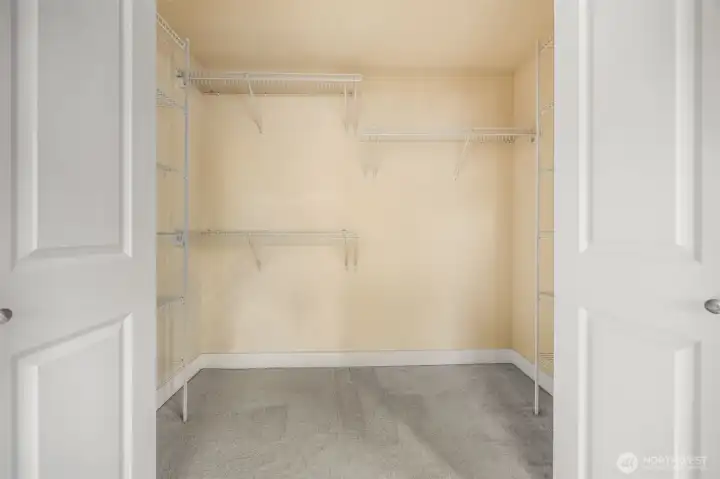 Sprawling primary bedroom walk-in closet.