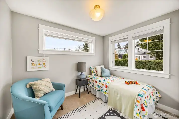 Second bedroom on upper floor following the theme of natural light through the many windows in this home.