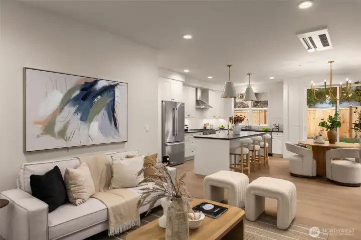 Living room open to kitchen and dining areas.