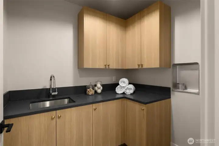 Upstairs laundry room with sink.