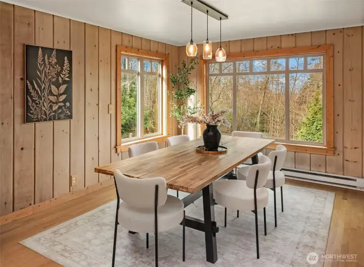 Generous dining area is surrounded by windows and overlooks the lower grounds.