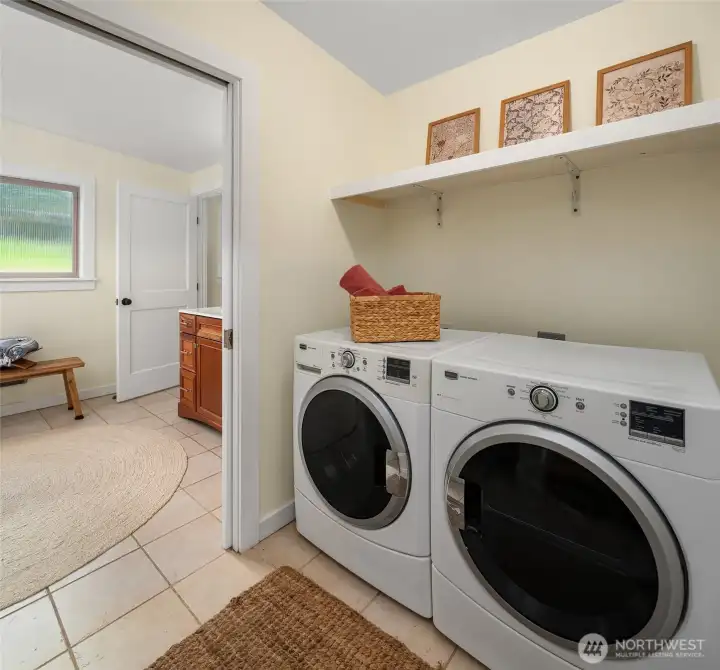Laundry is located between primary bath and main rooms.