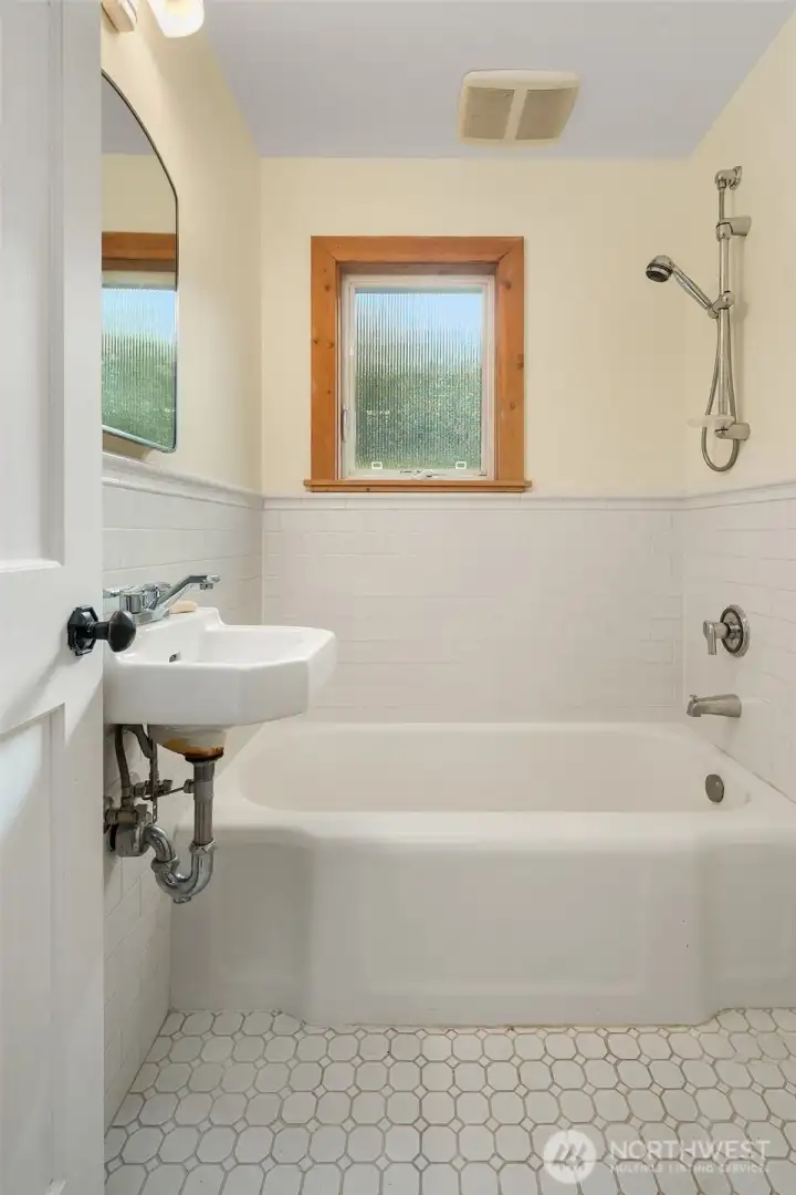 Second full bath off main living areas. Period fixtures and tile floor. Super cute!