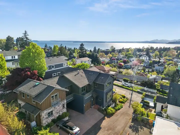 Perched above Alki Point with sweeping views of Puget Sound, this show-stopping home is ideal for multigenerational living or for those seeking a dedicated work-from-home space—just as the current owner has enjoyed on the lower level.