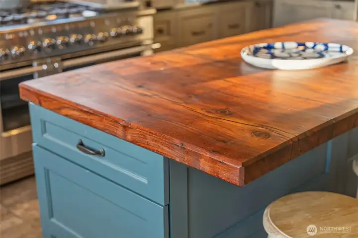 The walnut kitchen island and fireplace surround were both milled from a tree that once stood on the property—a thoughtful detail reflecting the owner’s commitment to preserving its heritage. The home also has a meaningful connection to the Ivar Haglund family; the seller notes that Ivar's childhood home previously stood here.