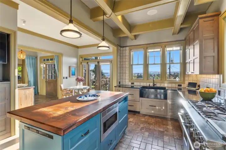 Overlooking Puget Sound, this kitchen is framed by expansive windows that capture glowing sunsets, turning everyday moments into something extraordinary. With ever-changing light and panoramic views as your backdrop, spending time here never loses its appeal.