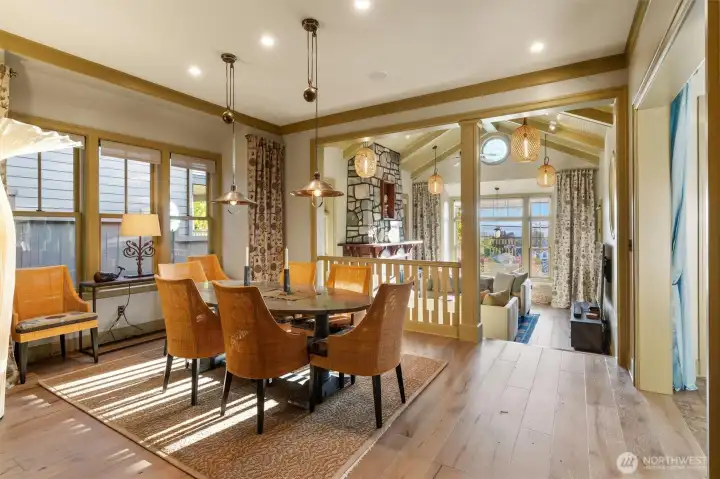 The dining room flows effortlessly into the living room, positioned at the front of the home and framed by beautiful views of the Sound. This thoughtful layout creates an ideal setting for both everyday living and entertaining, offering a natural sense of openness while still maintaining distinct, inviting spaces.