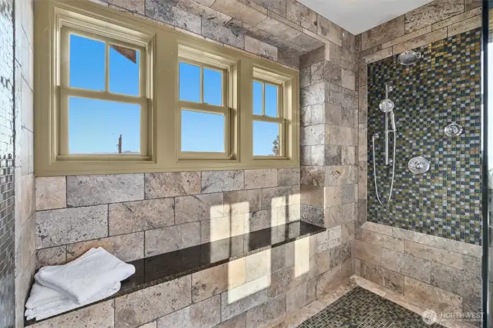 The walk-in shower in the primary bath offers a serene, spa-like experience—an ideal place to begin and end each day. With views from two directions and a beautifully light-filled design, the primary bath is sure to become one of the most cherished spaces in the home.