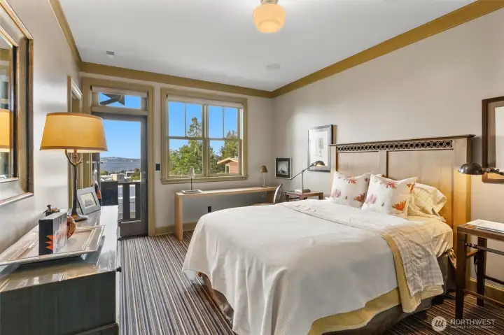 The first of two guest en-suites offers a comfortable and private retreat, each thoughtfully designed with its own view deck. The closets are well-appointed with integrated lighting and convenient electrical outlets, perfect for charging stick vacuums or powering other small devices.