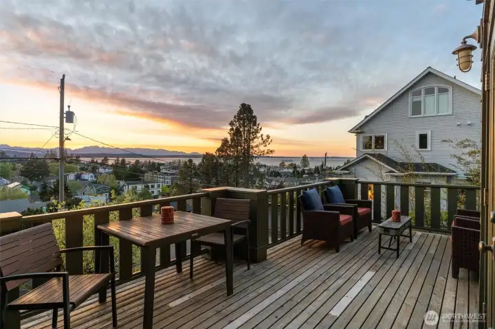 The front view deck is the perfect setting for entertaining, offering a welcoming outdoor space to gather with friends while enjoying spectacular sunsets.