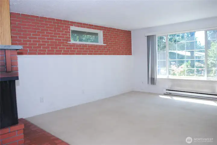 Generous living room and fireplace with plenty of natural light. View from the hallway leading to the bedrooms. Generous living room and fireplace with plenty of natural light. View from the hallway leading to the bedrooms.