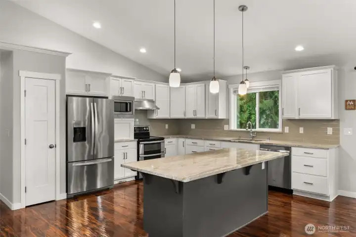 Beautiful kitchen with large island, solid countertops, stainless appliances, quality cabinets Beautiful kitchen with large island, solid countertops, stainless appliances, quality cabinets