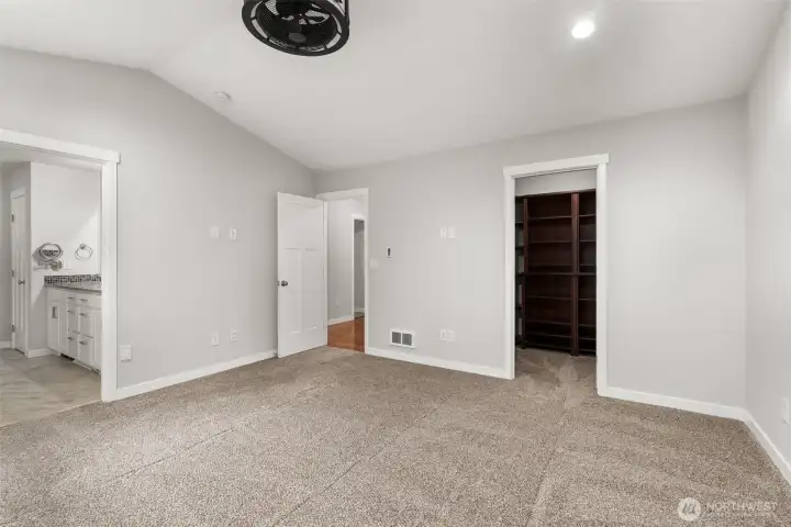 Primary Walk-in Closet with built-in shelves / cabinets Primary Walk-in Closet with built-in shelves / cabinets