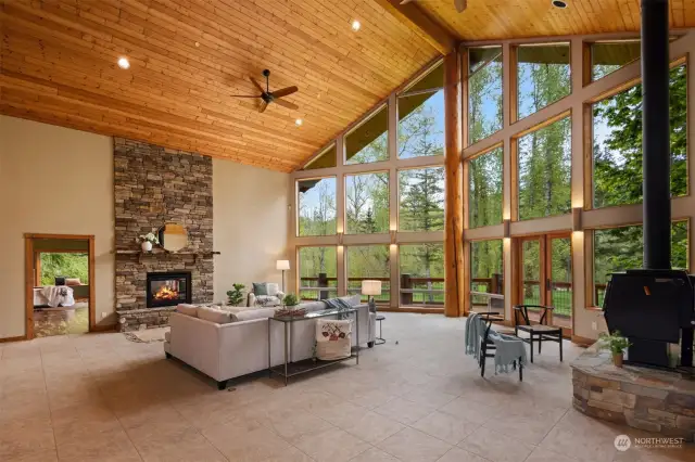 This space is so incredible for daily living as well as entertaining. With the heat from the wood-fired freestanding stove to the two sided gas fireplace insert which is shared by the primary suite.