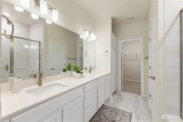 Under cabinet lighting and a linen closet in bathroom.