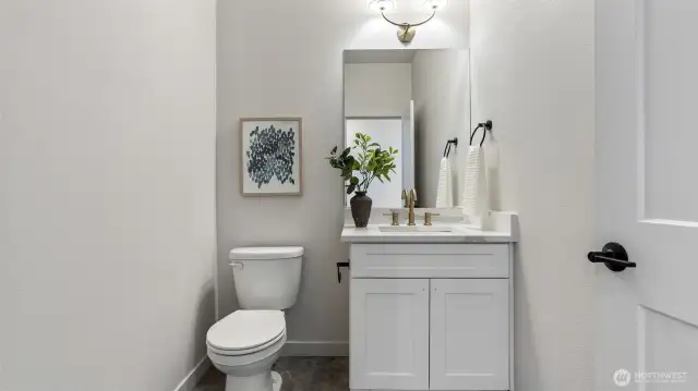Powder Room on main floor has toe kick heater and tile flooring.