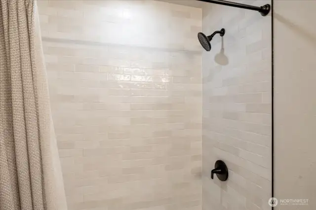 Brand new guest shower and tub with stunning tile