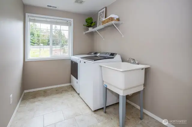 Massive utility room with convenient utility sink and room for more laundry tools!