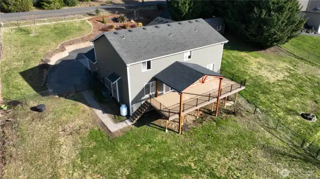 A nice pathway leads to acess the back deck from the side and back of the home. Notice the fully fenced and cross fenced property for keeping your loved ones safe.