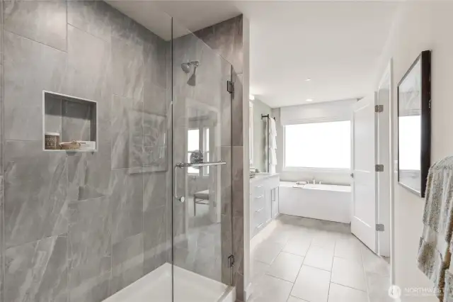 Large walk-in shower. Photo is representational. Actual home is under construction and materials, colors, and finishes will vary. See site agent for details.