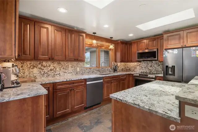 Gorgeous granite countertops and backsplash. Remodeled kitchen in 2022 with heated slate flooring. Lots of natural lights with skylights.
