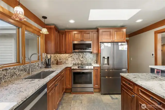 Lots of recessed lighting above and below the custom cabinets. Pull out garbage bin for easy clean up.