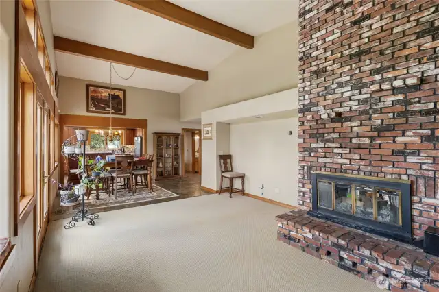 High vaulted ceilings with oak beams complement this great room. Enjoy this vintage 2 sided brick fireplace.