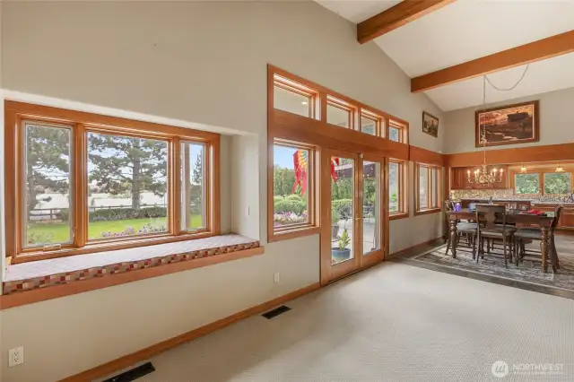 Great lake views and a room with window seat with storage. French doors lead to a spacious patio surrounded by beautiful flowers.