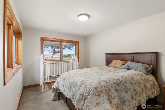 Secondary bedroom with views of the lake and built in shelving.