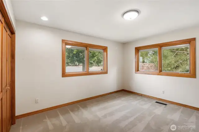 Third bedroom with lake views and beautiful oak trim and pine closet doors.