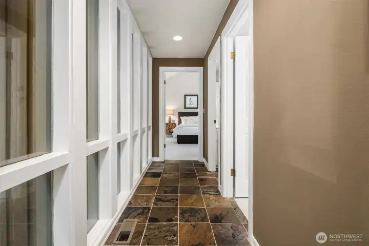 Main level hallway leading to bedrooms and hall bath. Loads of windows for extra light.