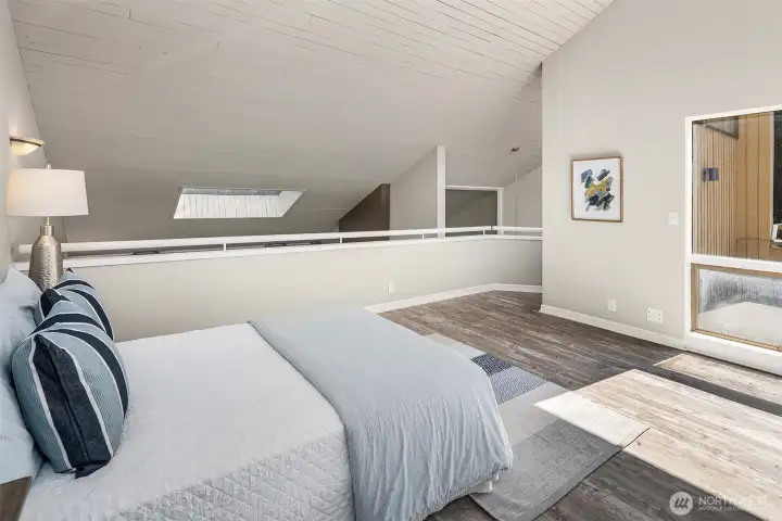 Upper level lofted second primary suite with 3/4 bath.