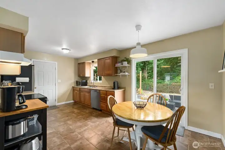 The kitchen has tile floors and a newer stove and dishwasher. The