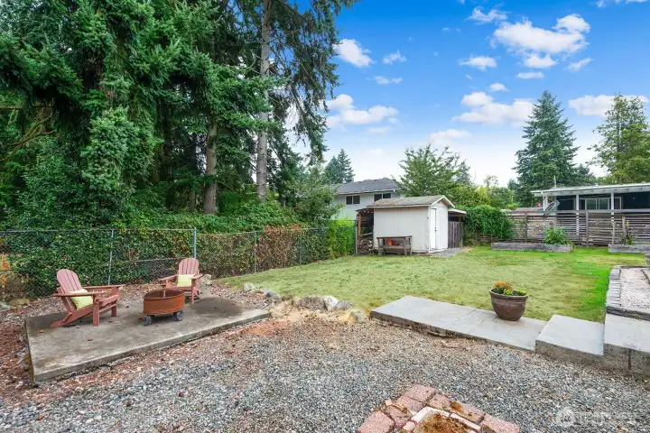 Large garden shed located next to the raised garden beds.
