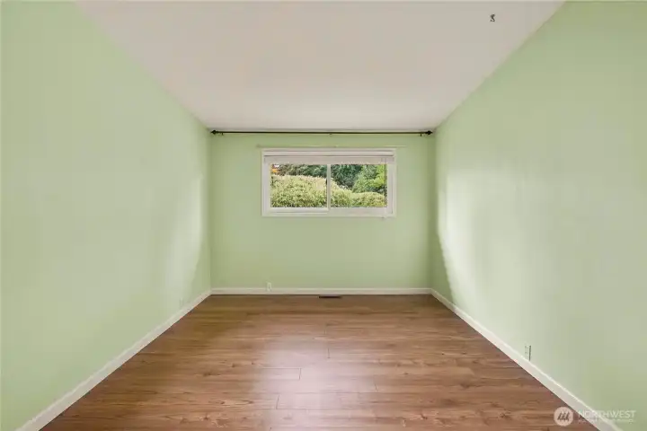 LVP Flooring and natural light are featured in this good sized bedroom