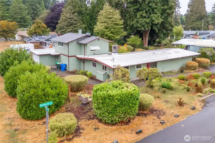 Enjoy the charm and privacy provided by mature trees and well-established landscaping